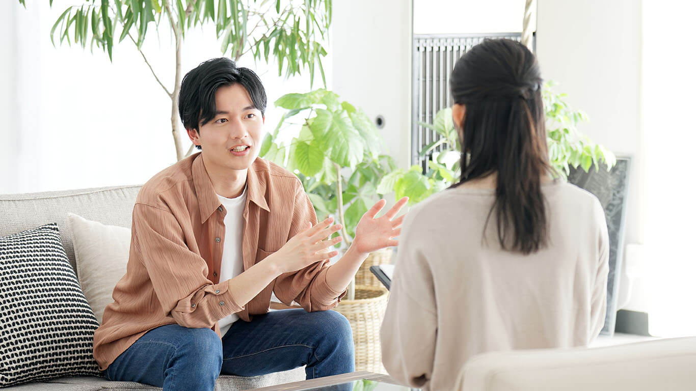 stock photo featuring a young man talking to an unidentified person